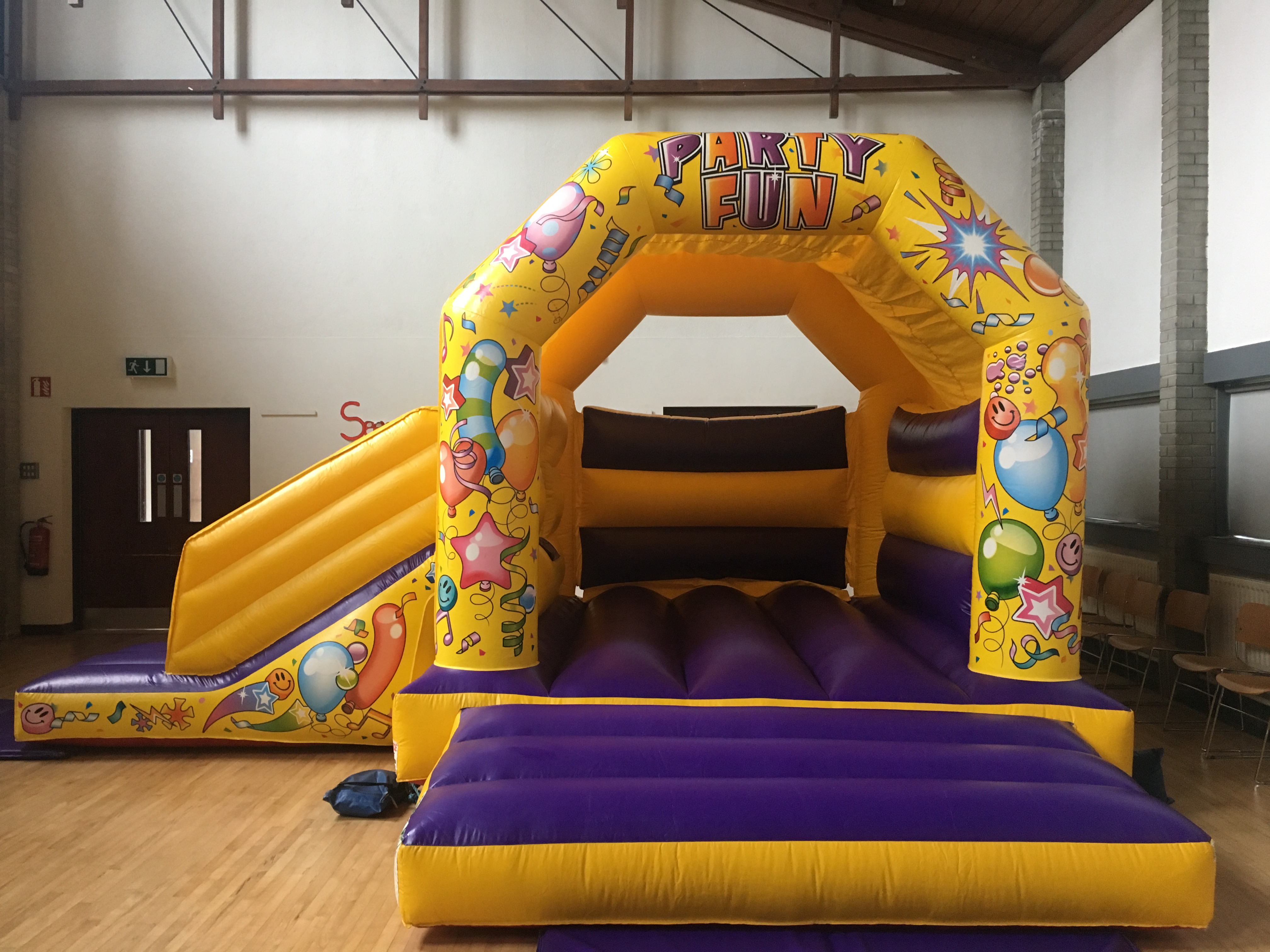 A bounce and slide bouncy castle for hire in a Bangor venue Bouncy castle hire Bangor